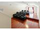 Home theater with hardwood floors, ceiling fan and comfortable seating for a great viewing experience at 3234 Cypress Grove Dr, Eustis, FL 32736