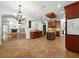 Bright kitchen with island, custom cabinets, and seamless flow into the living room and fireplace at 3234 Cypress Grove Dr, Eustis, FL 32736