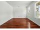 Light-filled living room features gleaming hardwood floors and bright windows at 3234 Cypress Grove Dr, Eustis, FL 32736