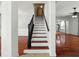 Staircase with white risers and wood treads, contrasted with black banister at 3234 Cypress Grove Dr, Eustis, FL 32736