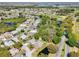 Community aerial view showcasing neighborhood streets, homes, lakes, and a nearby golf course at 32800 Oak Park Dr, Leesburg, FL 34748