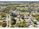 Panoramic aerial view of a residential community with mature trees, serene ponds, and a scenic golf course at 32800 Oak Park Dr, Leesburg, FL 34748