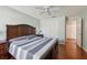 Well-lit bedroom with hardwood floors, ceiling fan, and large closet at 32800 Oak Park Dr, Leesburg, FL 34748