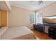 Guest bedroom features a window with shutters and hardwood flooring at 32800 Oak Park Dr, Leesburg, FL 34748