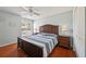 Bedroom with hardwood floors, ceiling fan and ample natural light from the window at 32800 Oak Park Dr, Leesburg, FL 34748