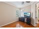 Bedroom featuring hardwood floors, shuttered windows, and a ceiling fan at 32800 Oak Park Dr, Leesburg, FL 34748