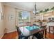 Dining room features hardwood floors, views of the back, and a chandelier with direct access to the kitchen at 32800 Oak Park Dr, Leesburg, FL 34748