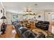 Open concept living room with hardwood floors, ceiling fan, lots of natural light, and an open kitchen area at 32800 Oak Park Dr, Leesburg, FL 34748