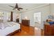 Spacious main bedroom featuring hardwood floors, ceiling fan, and Primary bath at 32800 Oak Park Dr, Leesburg, FL 34748