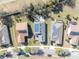 Overhead shot displaying solar panels on rooftops, well-maintained lawns, and mature trees along quiet neighborhood streets at 341 Silver Maple Rd, Groveland, FL 34736