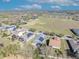 Aerial view showcasing residences with solar panels, screened patios, and meticulously maintained landscaping at 341 Silver Maple Rd, Groveland, FL 34736