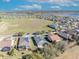 Aerial view highlighting residences with solar panels, screened patios, and meticulously maintained landscaping at 341 Silver Maple Rd, Groveland, FL 34736