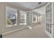 Bedroom with neutral carpet, three windows, and light beige paint at 341 Silver Maple Rd, Groveland, FL 34736