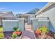 Inviting walkway leads to a beautifully landscaped entrance with black metal gate at 341 Silver Maple Rd, Groveland, FL 34736