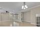 Bright living room with tile floors, ceiling fan, large windows, and contemporary lighting fixtures at 341 Silver Maple Rd, Groveland, FL 34736