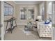 Home office with neutral carpet, two cream armchairs, and a console table at 341 Silver Maple Rd, Groveland, FL 34736