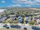 Street view of homes in neighborhood featuring solar panels, mature trees, and well-maintained lawns at 341 Silver Maple Rd, Groveland, FL 34736