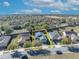 Street view of home and neighborhood featuring solar panels, mature trees, and well-maintained lawns at 341 Silver Maple Rd, Groveland, FL 34736