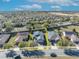 Street view of home and neighborhood featuring solar panels, mature trees, and well-maintained lawns at 341 Silver Maple Rd, Groveland, FL 34736