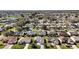 Overhead image showcasing homes in the community in an established neighborhood with mature landscaping at 3655 Idlewood Loop, The Villages, FL 32162