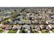 Aerial view of a home in a community with a lake nearby, displaying its location and neighborhood layout at 3655 Idlewood Loop, The Villages, FL 32162