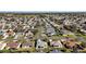 Aerial view of a neighborhood showcasing tree-lined streets, well-maintained homes, and community layout at 3655 Idlewood Loop, The Villages, FL 32162