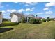 A lush green backyard offers plenty of space and privacy with mature landscaping around the home's perimeter at 3655 Idlewood Loop, The Villages, FL 32162