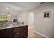 Beautiful dining area with granite countertops, dark-stained cabinets, and stainless steel appliances at 3655 Idlewood Loop, The Villages, FL 32162