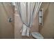 Enclosed shower with built-in shelving and a shower curtain, offering a clean and functional space at 3655 Idlewood Loop, The Villages, FL 32162