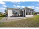 Relax in the sunroom with ample windows, accessible from the outdoor patio with table and chairs at 3655 Idlewood Loop, The Villages, FL 32162