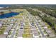Aerial view showcasing 3719 Holly Grove Lane and the surrounding neighborhood with a pond in the distance at 3719 Holly Grove Ln, Mount Dora, FL 32757