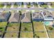 Aerial view of neighborhood homes featuring fenced backyards and solar panels on several roofs at 3719 Holly Grove Ln, Mount Dora, FL 32757