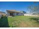 View of the backyard with a covered patio, lawn, and a white privacy fence at 3719 Holly Grove Ln, Mount Dora, FL 32757