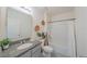 Bathroom featuring granite countertops, a large mirror, decorative accents, and a shower-tub combo at 3719 Holly Grove Ln, Mount Dora, FL 32757