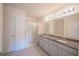 Bathroom with a double sink vanity, granite countertops, a large mirror, and a shower with sliding glass doors at 3719 Holly Grove Ln, Mount Dora, FL 32757