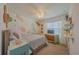 Comfortable bedroom with decorative wall accents, a painted dresser with a TV, and carpeted floor at 3719 Holly Grove Ln, Mount Dora, FL 32757