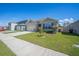 Charming single-story home featuring a well-manicured lawn, neutral paint, and an attached two-car garage at 3719 Holly Grove Ln, Mount Dora, FL 32757
