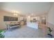 Open kitchen with a central island, stainless steel refrigerator, white cabinetry and dining area at 3719 Holly Grove Ln, Mount Dora, FL 32757