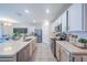 Open kitchen featuring white cabinets, stainless steel appliances, a large island, and seamless connection to the dining area at 3719 Holly Grove Ln, Mount Dora, FL 32757
