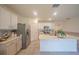 Bright kitchen featuring white cabinets, stainless steel appliances, and a large island with modern fixtures at 3719 Holly Grove Ln, Mount Dora, FL 32757