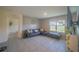 Comfortable living room featuring tile floors, modern furnishings, and natural light from a window at 3719 Holly Grove Ln, Mount Dora, FL 32757