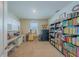 Spacious office with built-in storage, a desk, and a large bookcase filled with books at 3719 Holly Grove Ln, Mount Dora, FL 32757
