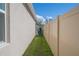 Narrow side yard with grass, a wooden fence, and access to the backyard at 3719 Holly Grove Ln, Mount Dora, FL 32757