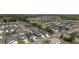 Panoramic aerial view of a residential community featuring a central pond and tree-lined streets at 3786 Stephanie Way, The Villages, FL 32163