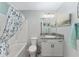 Well-lit bathroom features a shower/tub combo and an updated vanity with granite countertop at 3786 Stephanie Way, The Villages, FL 32163