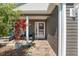 Inviting front porch with comfortable seating area and manicured landscaping, creating a welcoming entrance at 3786 Stephanie Way, The Villages, FL 32163