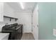 Modern laundry room with new appliances, ample counter space, and storage shelves at 3786 Stephanie Way, The Villages, FL 32163