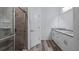 Bathroom featuring a glass shower enclosure, tiled walls, and a double vanity with granite counters at 40691 E 9Th Ave, Umatilla, FL 32784