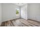 Bright bedroom with wood-look flooring, a window view and a ceiling fan for enhanced comfort at 40691 E 9Th Ave, Umatilla, FL 32784