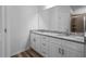 Bathroom featuring double sinks, granite countertops and white cabinets at 40706 E Ninth Ave, Umatilla, FL 32784